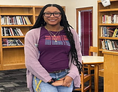  Ms. Hatfield standing in the library